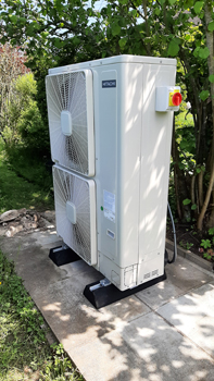 Air Source Heat Pump fan unit in garden
