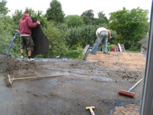 Old cover comes off. Stone chips re-used on driveway